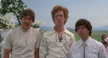 Movie still from “Napoleon Dynamite” (2004), directed by Jared Hess – A group of men standing next to each other in a field; Close Up shot, Low angle