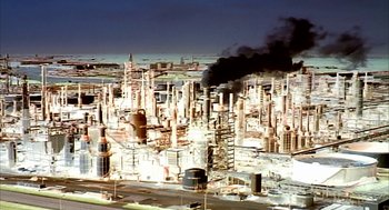 Movie still from “Naqoyqatsi” (2002), directed by Godfrey Reggio – An aerial view of an oil and gas refinery; Extreme Wide shot, High angle