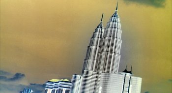 Movie still from “Naqoyqatsi” (2002), directed by Godfrey Reggio – A picture of the petronas twin towers in kuala lumpur; Extreme Wide shot, Low angle