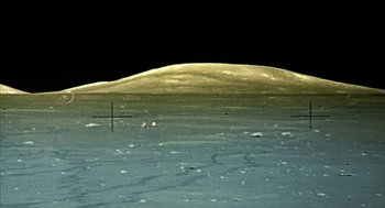 Movie still from “Naqoyqatsi” (2002), directed by Godfrey Reggio – A view of the moon taken from the lunar surface at night; Extreme Wide shot, High angle