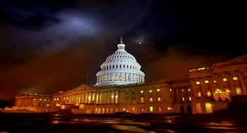 Movie still from “Naqoyqatsi” (2002), directed by Godfrey Reggio – A view of the united states capitol building at night; Extreme Wide shot, Low angle
