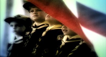 Movie still from “Naqoyqatsi” (2002), directed by Godfrey Reggio – A group of young men standing next to each other; Extreme Close Up shot, Low angle