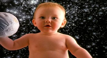 Movie still from “Naqoyqatsi” (2002), directed by Godfrey Reggio – A naked baby standing in front of a star filled sky; Extreme Close Up shot, Overhead angle