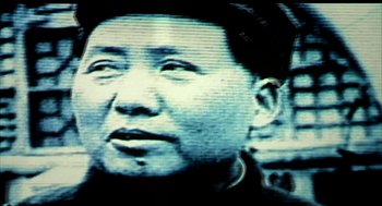 Movie still from “Naqoyqatsi” (2002), directed by Godfrey Reggio – An image of a man that is looking at the camera; Extreme Close Up shot, Low angle