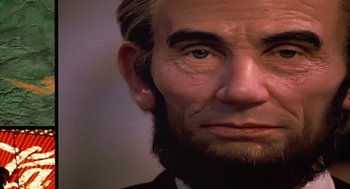 Movie still from “Naqoyqatsi” (2002), directed by Godfrey Reggio – A person's face with a beard; Extreme Close Up shot, Low angle