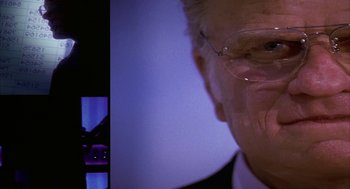 Movie still from “Naqoyqatsi” (2002), directed by Godfrey Reggio – An older man wearing glasses and a suit and tie; Close Up shot, Low angle