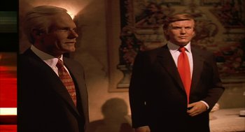 Movie still from “Naqoyqatsi” (2002), directed by Godfrey Reggio – Two men in suits stand next to each other in a room; Medium shot, Low angle