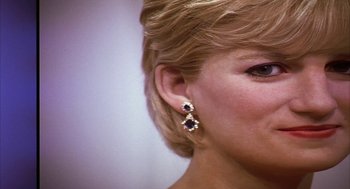 Movie still from “Naqoyqatsi” (2002), directed by Godfrey Reggio – A woman's face with a pair of earrings; Close Up shot, Over the shoulder angle