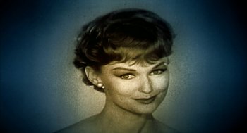 Movie still from “Naqoyqatsi” (2002), directed by Godfrey Reggio – An old photo of an older woman with short hair; Close Up shot, Low angle