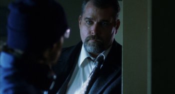 Movie still from “Narc” (2002), directed by Joe Carnahan – A man in a suit and tie looking into a mirror; Close Up shot, Over the shoulder angle