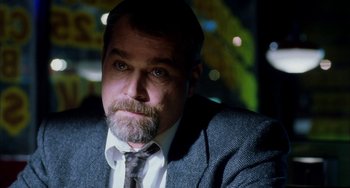Movie still from “Narc” (2002), directed by Joe Carnahan – A person wearing a suit and tie; Close Up shot, Low angle