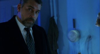 Movie still from “Narc” (2002), directed by Joe Carnahan – A person wearing a suit and tie; Close Up shot, Low angle
