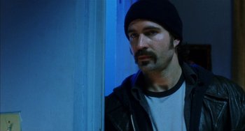 Movie still from “Narc” (2002), directed by Joe Carnahan – A man wearing a black hat and a white t - shirt; Close Up shot, Low angle