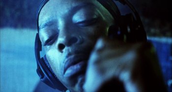 Movie still from “Narc” (2002), directed by Joe Carnahan – A person with headphones on; Extreme Close Up shot, Low angle