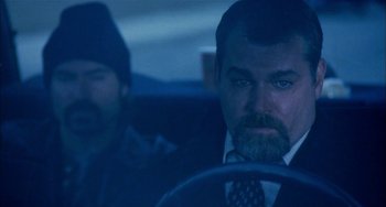 Movie still from “Narc” (2002), directed by Joe Carnahan – A man in a suit and tie sitting in a car next to another man in a suit; Close Up shot, Over the shoulder angle