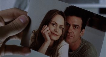 Movie still from “Narc” (2002), directed by Joe Carnahan – A man and a woman are holding a picture; Extreme Close Up shot, Low angle