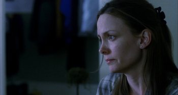 Movie still from “Narc” (2002), directed by Joe Carnahan – A person looking sad; Close Up shot, Over the shoulder angle