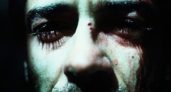 Movie still from “Narc” (2002), directed by Joe Carnahan – A man's eyes with blood on them; Extreme Close Up shot, Overhead angle