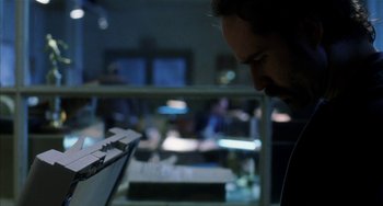 Movie still from “Narc” (2002), directed by Joe Carnahan – A man looking at a keyboard in a room; Close Up shot, Low angle