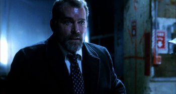 Movie still from “Narc” (2002), directed by Joe Carnahan – A person wearing a suit and tie; Close Up shot, Low angle