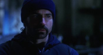 Movie still from “Narc” (2002), directed by Joe Carnahan – A person wearing a blue hat; Close Up shot, Low angle