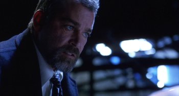 Movie still from “Narc” (2002), directed by Joe Carnahan – A person wearing a suit and tie; Close Up shot, Low angle