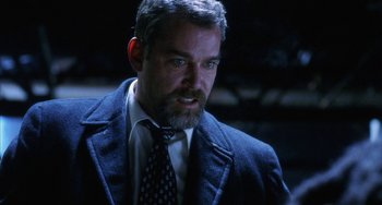 Movie still from “Narc” (2002), directed by Joe Carnahan – A person wearing a suit and tie; Close Up shot, Over the shoulder angle