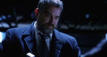 Movie still from “Narc” (2002), directed by Joe Carnahan – A person wearing a suit and tie; Close Up shot, Low angle