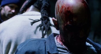 Movie still from “Narc” (2002), directed by Joe Carnahan – A person's face with blood on his face; Extreme Close Up shot, Over the shoulder angle