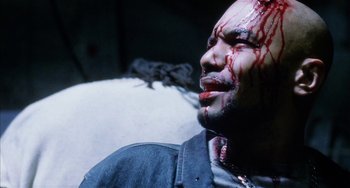 Movie still from “Narc” (2002), directed by Joe Carnahan – A person with blood on his face; Close Up shot, High angle