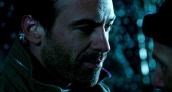 Movie still from “Narc” (2002), directed by Joe Carnahan – A man's face in a dark room; Close Up shot, Over the shoulder angle