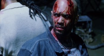 Movie still from “Narc” (2002), directed by Joe Carnahan – A person with blood on his face; Close Up shot, High angle