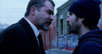 Movie still from “Narc” (2002), directed by Joe Carnahan – A man and a man face each other in a street corner; Close Up shot, Over the shoulder angle