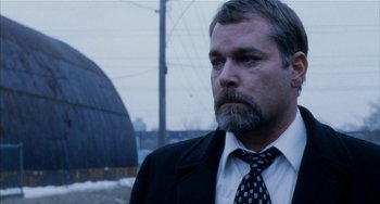 Movie still from “Narc” (2002), directed by Joe Carnahan – A person wearing a suit and a tie; Close Up shot, Low angle