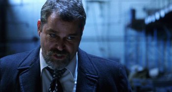 Movie still from “Narc” (2002), directed by Joe Carnahan – A person wearing a suit and tie; Close Up shot, Low angle