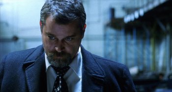 Movie still from “Narc” (2002), directed by Joe Carnahan – A person wearing a suit and tie; Close Up shot, Low angle