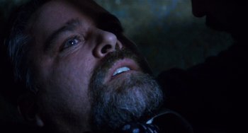 Movie still from “Narc” (2002), directed by Joe Carnahan – A person with a beard; Close Up shot, Overhead angle