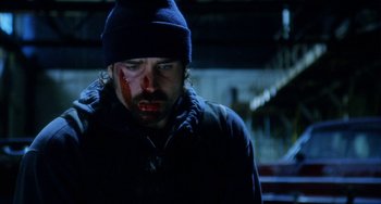 Movie still from “Narc” (2002), directed by Joe Carnahan – A man with a bandage on his face; Close Up shot, Low angle