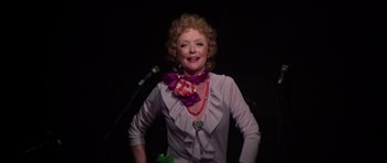 Movie still from “Nashville” (1975), directed by Robert Altman – An older woman standing in front of a microphone; Medium shot, Low angle