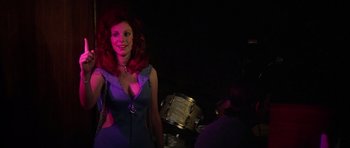 Movie still from “Nashville” (1975), directed by Robert Altman – A woman with red hair and a purple dress; Medium shot, Low angle