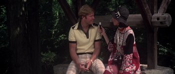 Movie still from “Nashville” (1975), directed by Robert Altman – A man and a woman are sitting on a bench; Medium shot, Over the shoulder angle