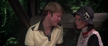 Movie still from “Nashville” (1975), directed by Robert Altman – A young man sitting next to another man on a park bench; Close Up shot, Over the shoulder angle