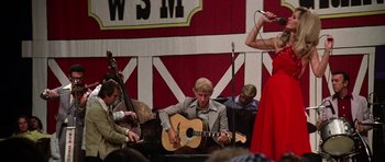 Movie still from “Nashville” (1975), directed by Robert Altman – A group of people sitting around a stage playing music; Wide shot, Low angle