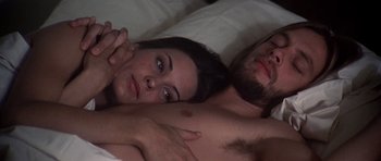 Movie still from “Nashville” (1975), directed by Robert Altman – A man and a woman laying in a bed together; Close Up shot, Overhead angle