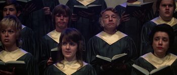 Movie still from “Nashville” (1975), directed by Robert Altman – A group of people standing in choir robes holding books; Close Up shot, Low angle