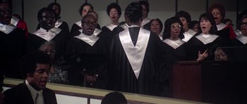 Movie still from “Nashville” (1975), directed by Robert Altman – A group of people in choir uniforms singing; Medium shot, High angle