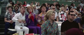 Movie still from “Nashville” (1975), directed by Robert Altman – A group of people sitting in a crowd watching a performance; Medium shot, Low angle