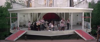 Movie still from “Nashville” (1975), directed by Robert Altman – A group of people on a stage playing music; Wide shot, High angle