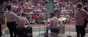Movie still from “Nashville” (1975), directed by Robert Altman – Two men playing drums in front of an audience; Wide shot, High angle