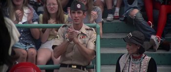 Movie still from “Nashville” (1975), directed by Robert Altman – A man in uniform clapping while sitting in a crowd; Medium shot, Low angle